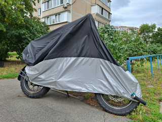 Cover on a motorcycle parked near a house © Harmony Video Pro