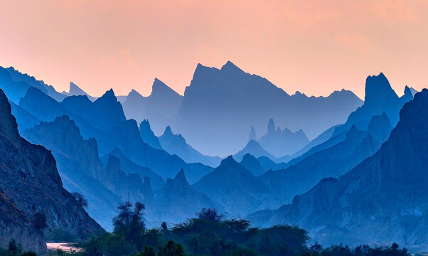 View of the jagged mountain peaks and layered rock formations along the Makran Coastal Highway during a colorful sunset Makran, Balochistan, Pakistan.