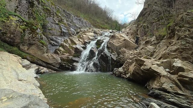 Rippling water falls over mossy stones. Vucjanka Canyon, near Leskovac. Balkans, Serbia.