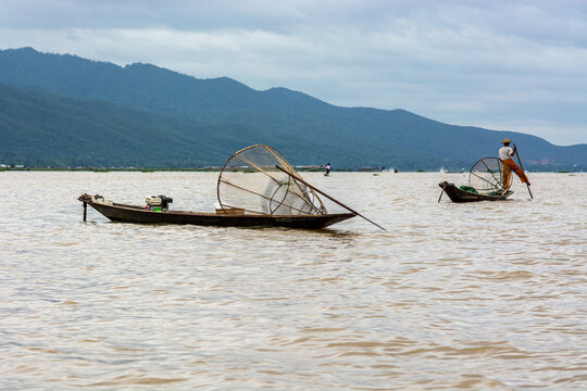 Traditional fishermen with conical nets on Inle Lake, Myanmar