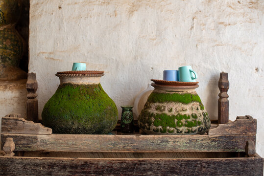 Traditional moss-covered terracotta water pots (Ye Gyan Zin), Myanmar.