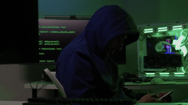 Solo software engineer working through technical issues late at night. Dedicated coder in dim lighting diagnosing problems on open computer case with intense concentration