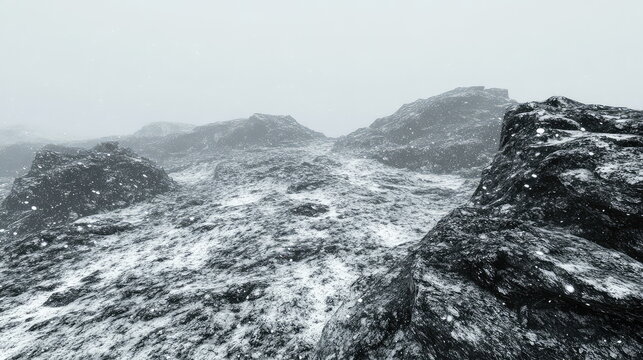 Snow dusted rocky mountain ridges under a grey sky, snowflakes drifting in a cold, misty high altitude wilderness, evoking harsh, serene winter solitude and blizzard weather