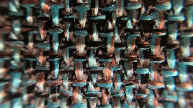 4k macro footage of a multicolored thread fabric depicting cloth texture, patterns and structure