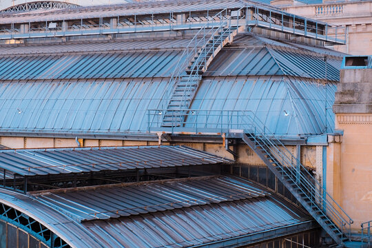 Paris, France: Industrial metal rooftop and maintenance stairs in Gare de l'Est, the historic station featured in cinematic classics like Amelie.