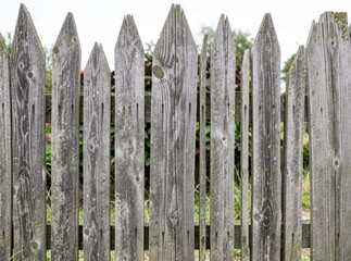 Obraz premium A close-up view of a wooden fence with a red fire attached to it