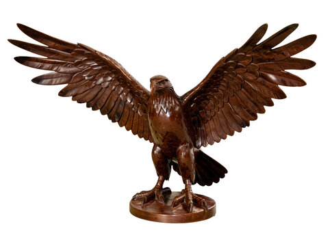 A bronze eagle perched on a wooden pedestal