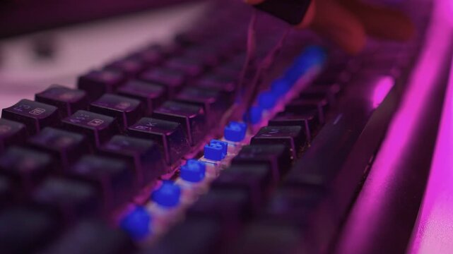 Removing and replacing keyboard keycaps. Detailed view of keycap swapping on keyboard. Vivid scene demonstrating removal and installation of keycaps on mechanical keyboard