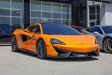 Fototapeta premium McLaren 570GT Base display at a dealership. McLaren offered the 570GT with a 3.8L Twin-Turbocharged V8 engine. MY:2018