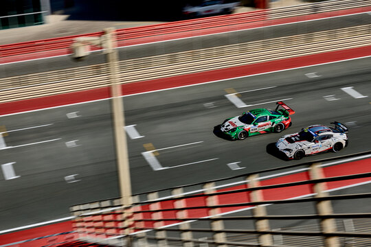 UAE, Dubai, 18 January 2026: 24h series racing supercars on the circuit, Battle of the teams, long exposure photography, supercars drive past at high speed, pitstops, training runs, watching people, 