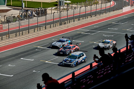 UAE, Dubai, 18 January 2026: 24h series racing supercars on the circuit, Battle of the teams, long exposure photography, supercars drive past at high speed, pitstops, training runs, watching people, 