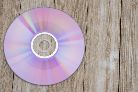 Compact disc background on rustic wood desk