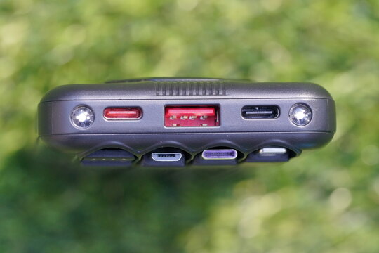 Cell phone charger with various connection outputs and flashlight