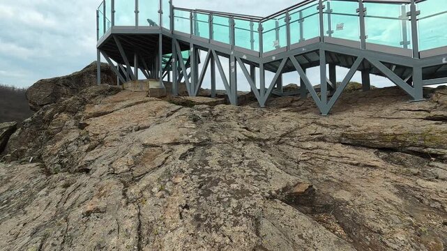 Glass walkway hugs jagged rock face. Vucjanka Canyon, near Leskovac. Balkans, Serbia.