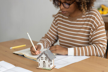 close up view of house layout that stands on table. female architect is working on creating house layout. house construction, sale and purchase of real estate. concept of working in a home office. © MyJuly