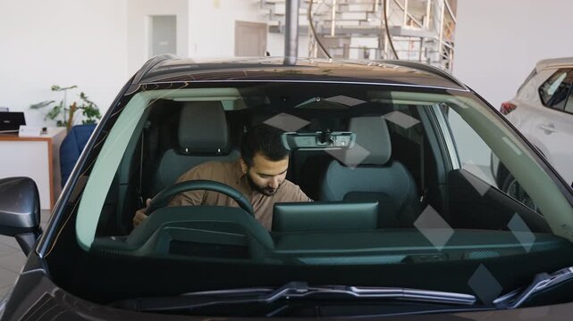 Happy Indian man buying new car at dealership showroom