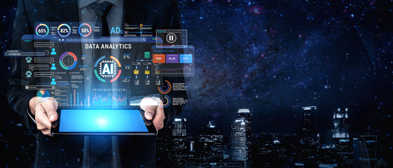 Obraz premium Businessman Holding Tablet Displaying Data Analytics Interface with AI Insights and Digital Graphs in Night Cityscape Background Fluxor.