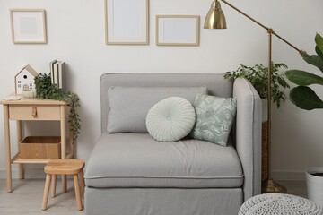 Fototapeta premium Stylish modular sofa, houseplants and furniture in room. Interior design