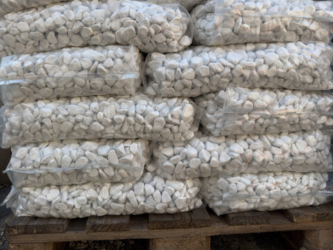 White pebbles in plastic bags on pallet
