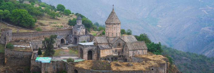 Exterior of an Armenian Apostolic church, showcasing traditional stone architecture, conical domes, and intricate historical design reflecting centuries of religious and cultural heritage. © Daniel
