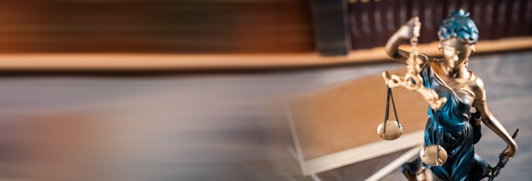 Justice-themed statue with scales, gavel, and books, symbolizing fairness, equality, and the principles of law and moral judgment.