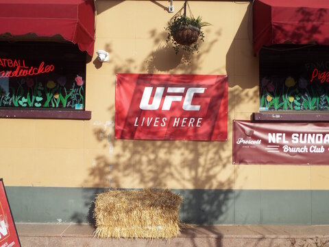 Ottawa, Ontario, Canada &ndash; August 02, 2025: The exterior of The Prescott features a "UFC banner", an NFL Sunday Brunch Club sign, and a bale of hay on Orangeville St.