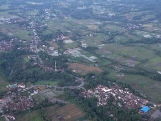 Fototapeta premium Aerial View of Rural Village with Agricultural Fields and Residential Areas