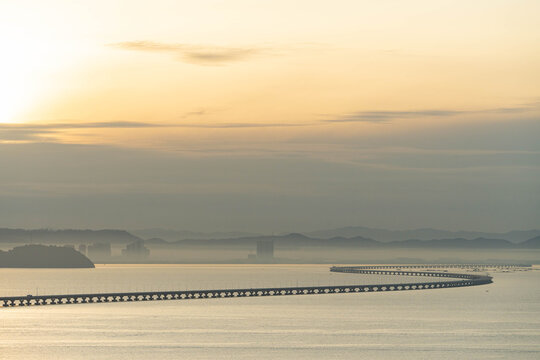 a serene sunset on Sultan Abdul Halim Muadzam Shah Bridge also known as Penang Second Link Bridge and a mist on the main island