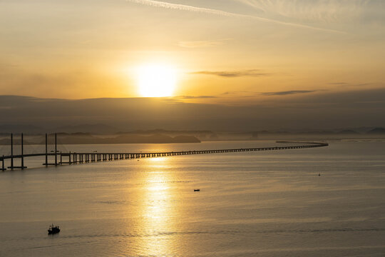a serene sunset on Sultan Abdul Halim Muadzam Shah Bridge also known as Penang Second Link Bridge and a mist on the main island