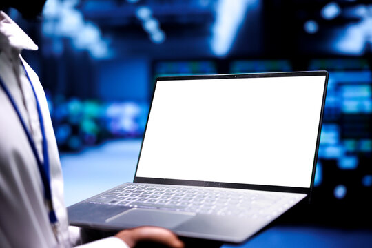 Manager inspecting server rackmounts doing intense computations. Supervisor using mock up tablet to assess strain on cloud computing business caused by AI applications driving up power usage