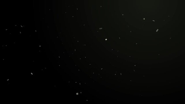 Subtle dust particles float in a beam of light against dark black background movement