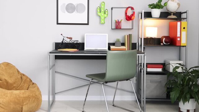 Stylish workplace with laptop and stationery in child's room, camera moving up