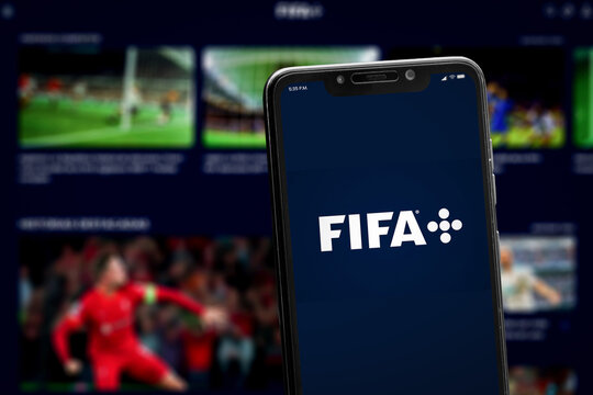 Cali, Colombia - April 20 2022: Smartphone displaying FIFA+ logo against blurred football streaming interface.