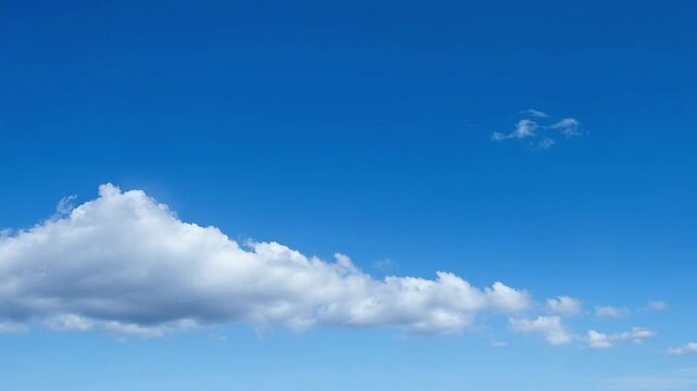 Fluffy white clouds against a vibrant blue sky