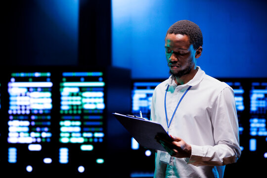 Technician doing annual maintenance, helping prolong equipment life span and avoiding downtime. Admin monitoring server hardware components for issues such as overheating or power fluctuations