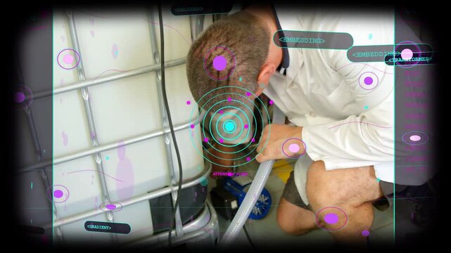 Vertical video: Checking shop IBC, kneeling tech fitting hose to blue pump with HUD, white shirt