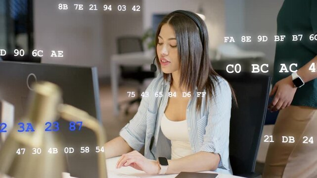 Agent typing talking into headset launching code overlay on monitor while peer helping tech support
