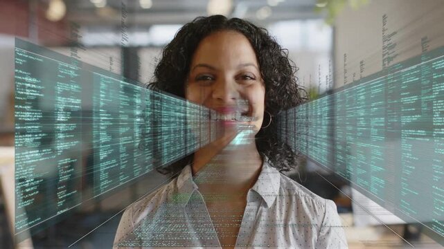 Woman standing center in tech office, data panels arising from edges closing sweeping face for demo