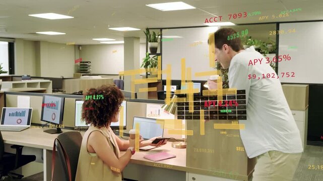 Woman at desk accepting coffee from colleague, pointing and reviewing floating finance charts