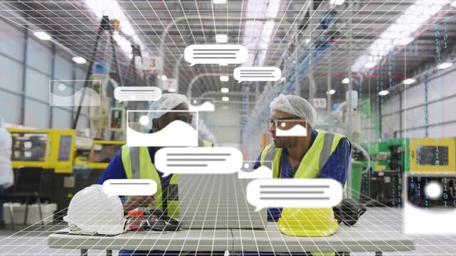 Two factory techs leaning over laptop pointing and initiating grid and icon overlays while doing QC