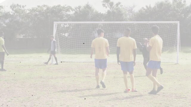 Defensive wall reacting while kicker striking ball in soccer, animated arc showing goal prevention