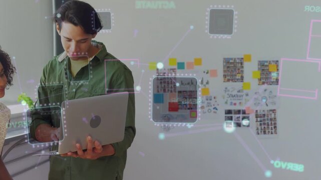 Man using laptop, tilting, typing, animating holo nodes on board for design review, team gathering