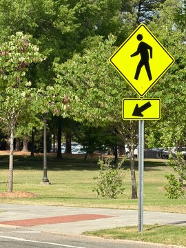 Yellow pedestrian crossing sign with a shallow depth of field