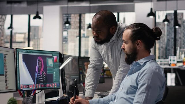 Diverse photographers working on image selection and retouching on editing software, color correction for commercial materials and catalog results. Post production agency in office studio.