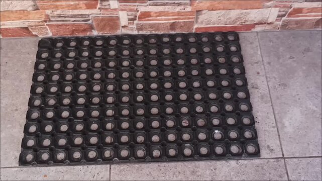 High angle shot of a non-slip rubber hollow mat with hexagonal holes, ideal for industrial drainage and safety floors