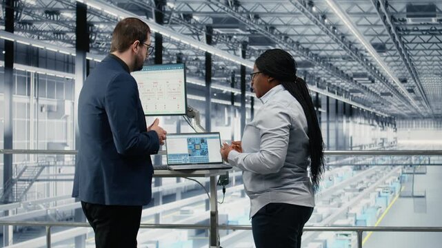 Businesspeople team optimizes PCB smart factory workflow using EDA software on laptop. Employees using notebook simulation program tracking semiconductor production circuit layout defects, camera A