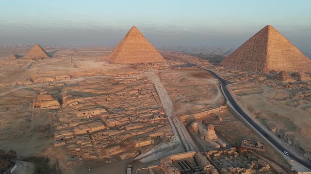 Panorama drone shoot of pyramids of Giza and sphinx at sunrise time - Egypt