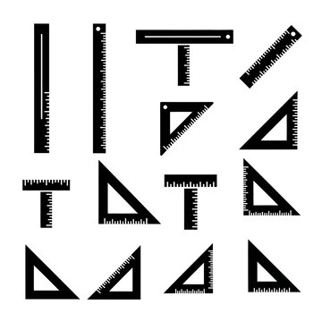 Collection of black drafting triangles and rulers on white background