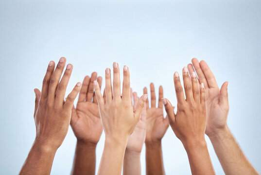 Diverse hands raised high symbolizing voting or unanimous agreement