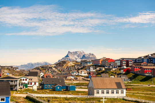 View of colorful houses and the iconic Sermitsiaq mountain under a clear blue sky in Nuuk, Sermersooq Municipality, Greenland.